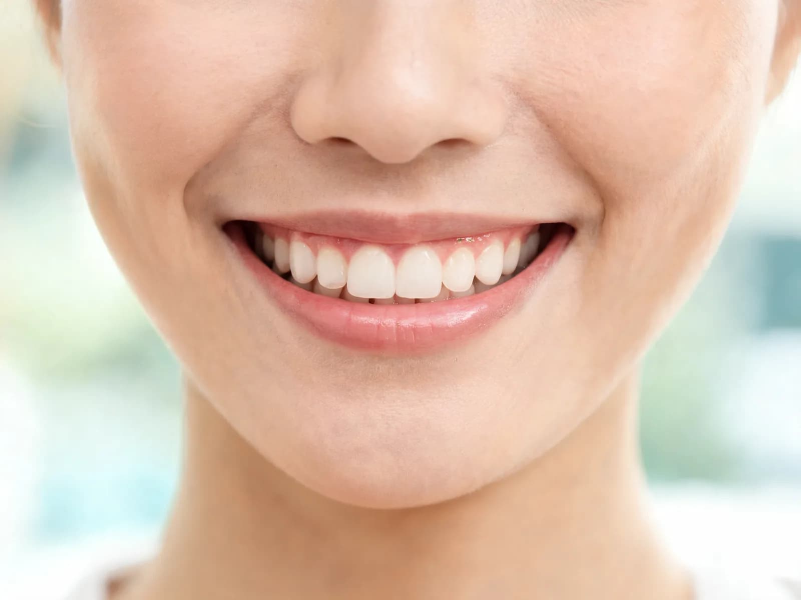 Close-up of a smile with natural teeth and an even, balanced gum line